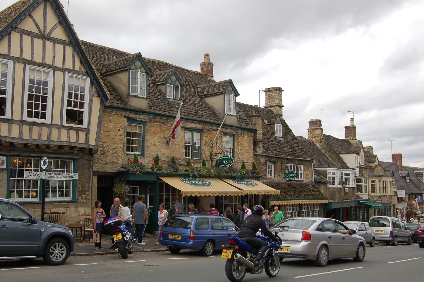 The High Street in Burford running downhill between stone buildings