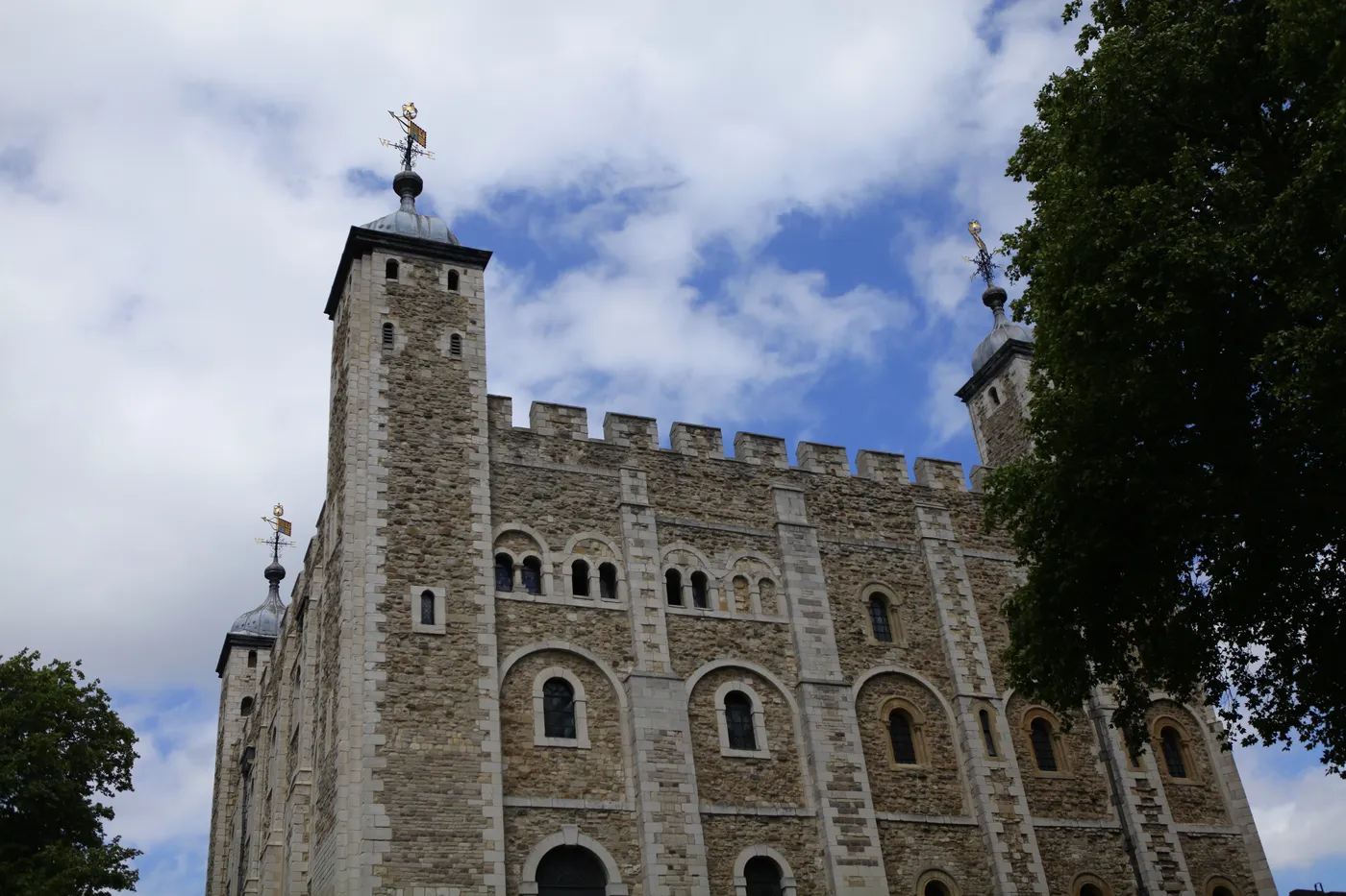 The White Tower, the Norman stone keep of the Tower of London, with its corner turrets against a blue sky