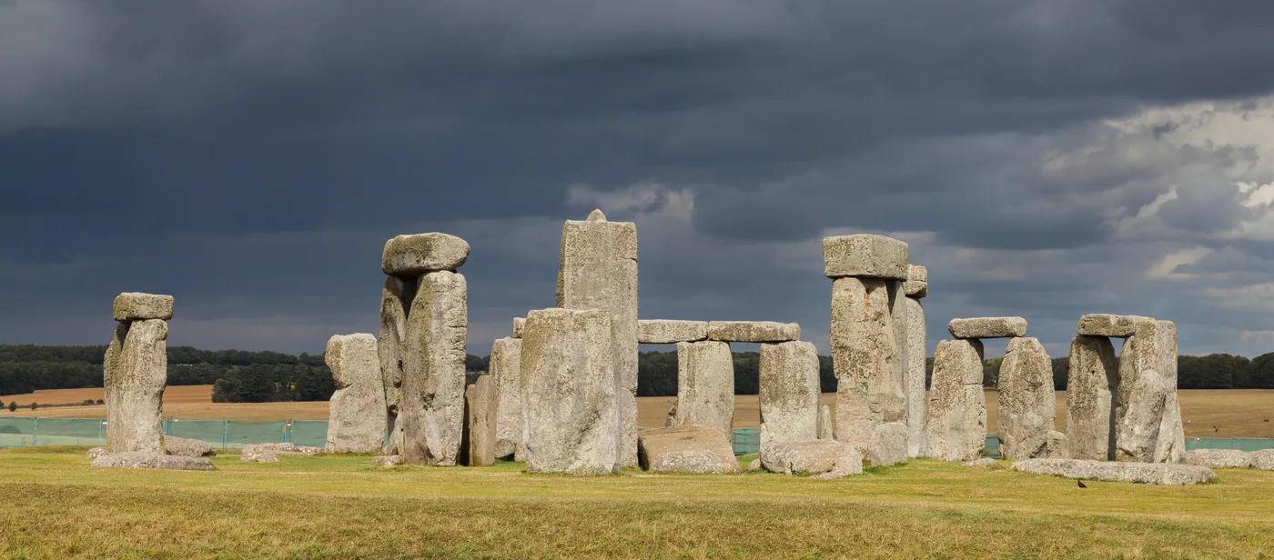 Wide view of the Stonehenge stone circle on Salisbury Plain under a cloudy sky